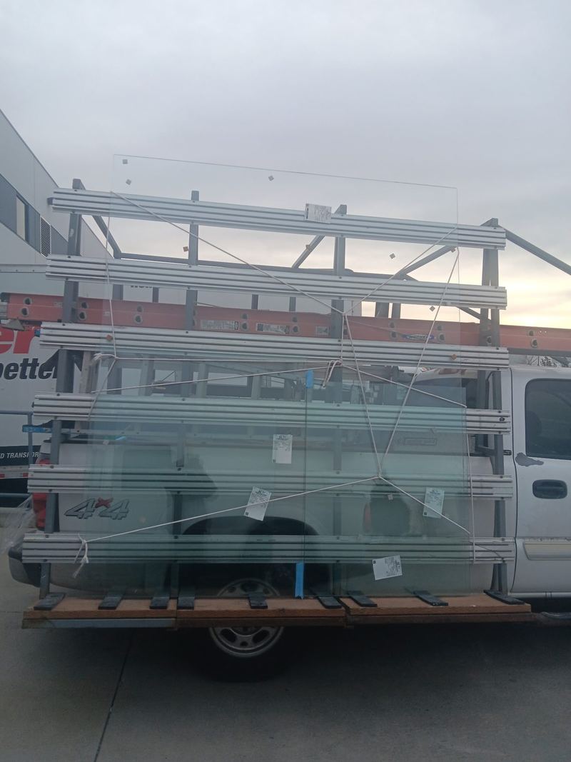 A glass rack van loaded with cut glass panels standing on edge ready for delivery