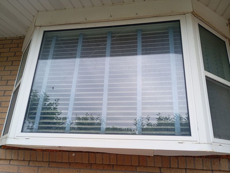 A replacement bay window fitted into a brick home exterior